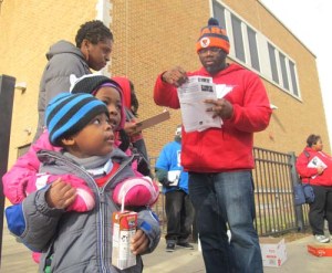 CTU organizer Brandon Johnson passes out leaflets and petitions to canvassers at Lewis Elementary.  Photo from http://www.substancenews.net/articles.php?page=3899